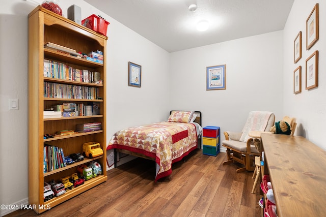 bedroom with wood-type flooring