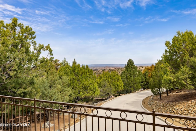 balcony featuring a view of trees