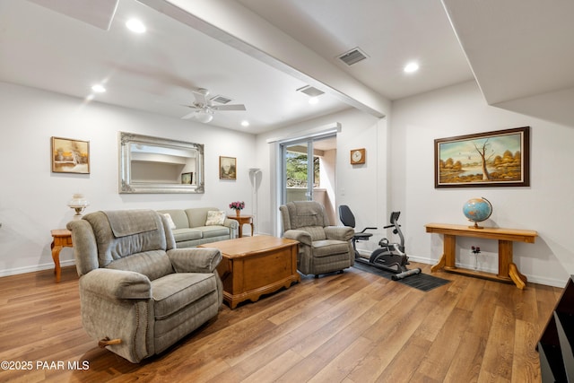living area featuring baseboards, visible vents, light wood-style floors, ceiling fan, and recessed lighting