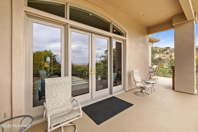 exterior space with a balcony and stucco siding