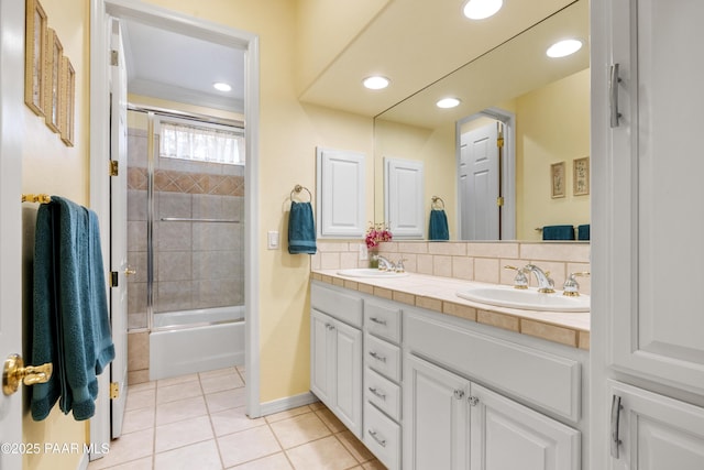 bathroom with tile patterned floors, a sink, tasteful backsplash, and double vanity