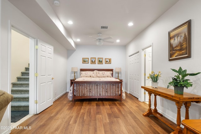 bedroom featuring recessed lighting, baseboards, ceiling fan, visible vents, and wood finished floors
