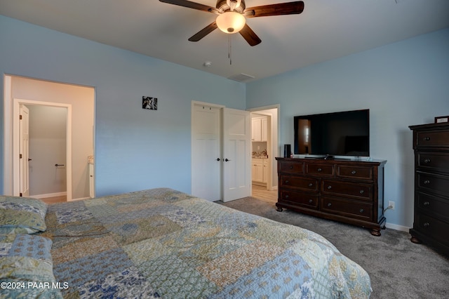 bedroom with carpet flooring, ensuite bath, and ceiling fan