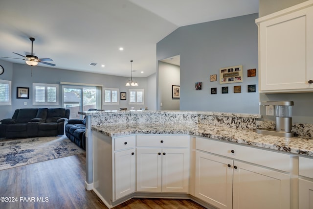 kitchen with ceiling fan with notable chandelier, dark hardwood / wood-style floors, white cabinetry, and lofted ceiling