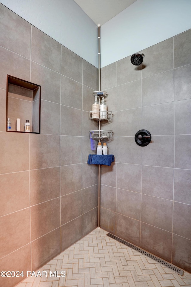 bathroom with tiled shower