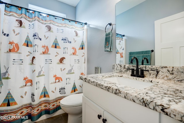 bathroom featuring curtained shower, tile patterned flooring, vanity, and toilet