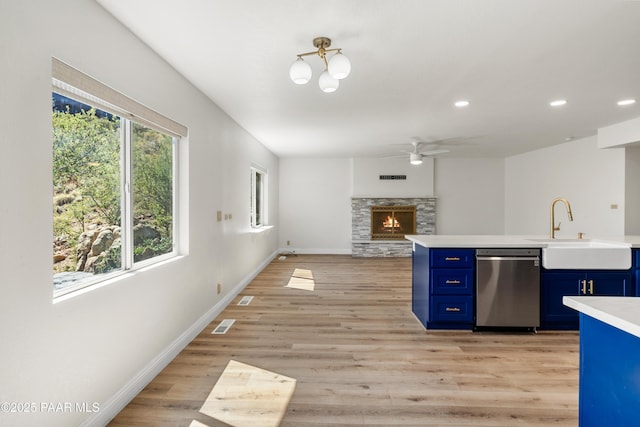 902 Fern Dr, Prescott, AZ 86305 - kitchen with blue cabinets, stainless steel dishwasher, a sink, light countertops, and ceiling fan