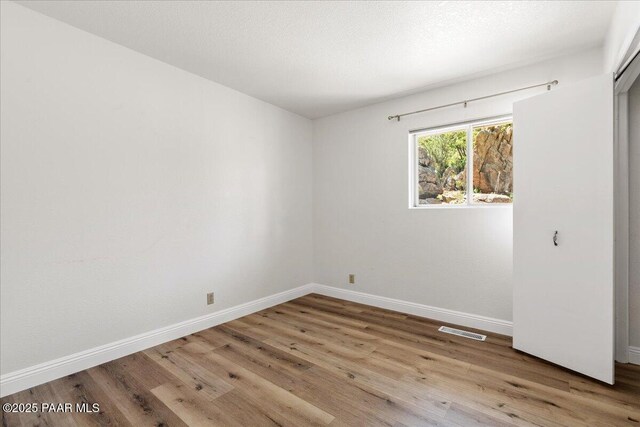 902 Fern Dr, Prescott, AZ 86305 - unfurnished bedroom featuring wood finished floors and baseboards