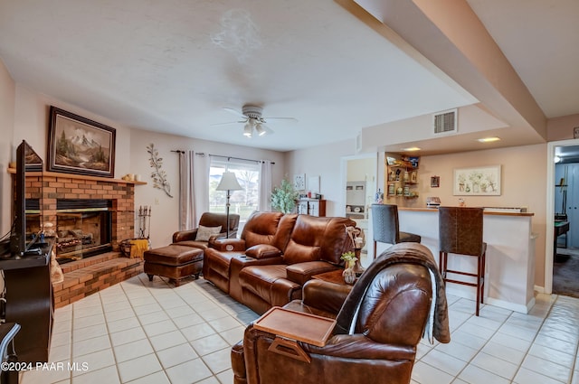 10701 E Stirrup High Dr Unit W, Dewey-Humboldt, AZ 86327 - living room featuring light tile patterned flooring, a brick fireplace, ceiling fan, and visible vents