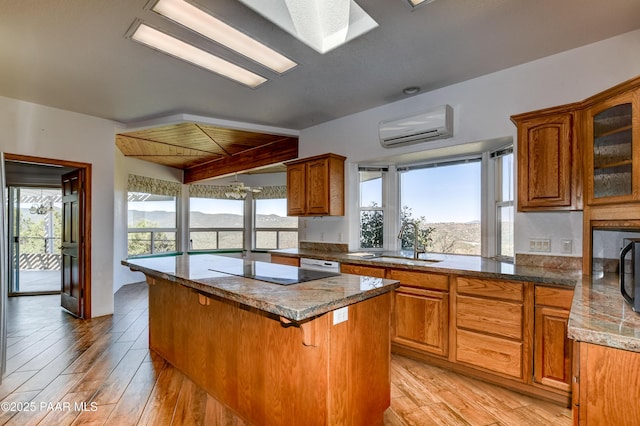 58 N French Pl, Prescott, AZ 86303 - kitchen with a sink, a center island, a wall unit AC, and light wood-type flooring
