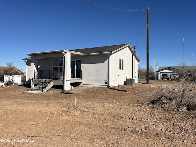 rear view of house featuring central air condition unit