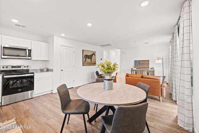 dining space with light wood-type flooring