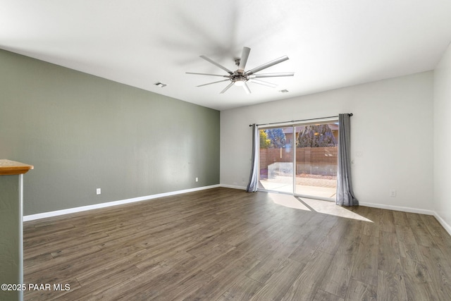 empty room featuring ceiling fan and dark hardwood / wood-style floors