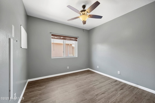 empty room featuring hardwood / wood-style floors and ceiling fan