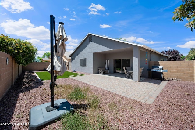 rear view of property featuring a patio