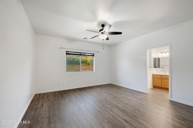 spare room featuring hardwood / wood-style floors and ceiling fan