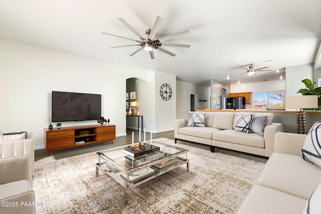 living room featuring light wood-type flooring and ceiling fan