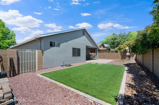 back of property with a patio area and a lawn