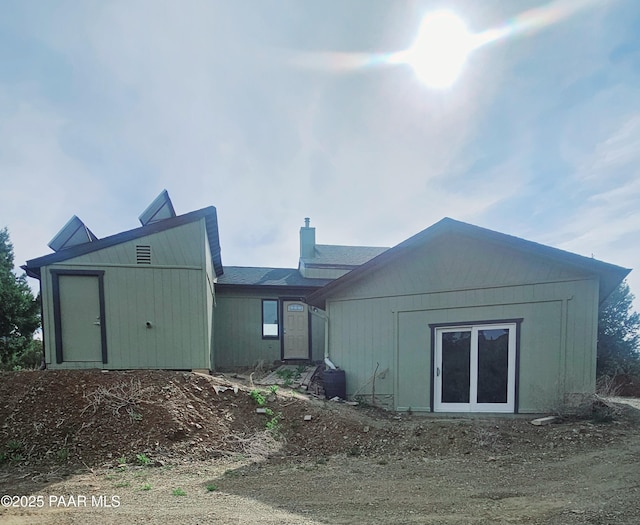 back of property with a chimney