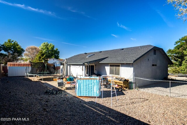 6126 N Little Papoose Dr, Prescott Valley, AZ 86314 - rear view of property with a trampoline, a shingled roof, a patio area, and a shed