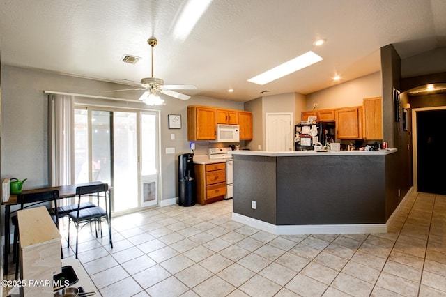 6126 N Little Papoose Dr, Prescott Valley, AZ 86314 - kitchen with white appliances, light countertops, light tile patterned floors, brown cabinets, and a ceiling fan