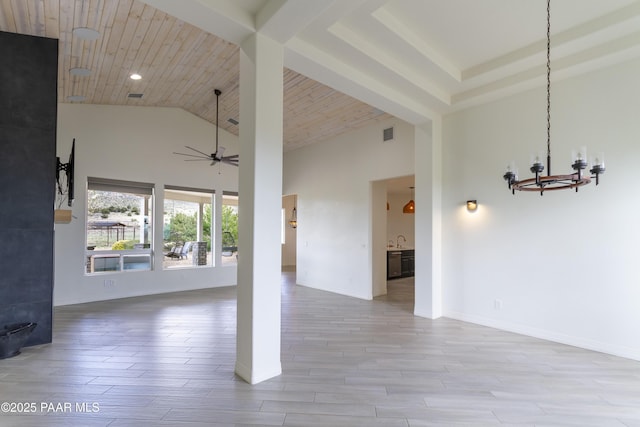 interior space featuring ceiling fan with notable chandelier, wood finished floors, high vaulted ceiling, wood ceiling, and baseboards