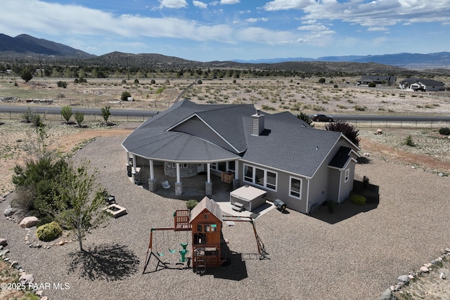 bird's eye view with a mountain view, a rural view, and view of desert