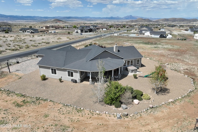 birds eye view of property featuring a mountain view
