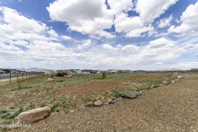 view of yard with a mountain view and fence