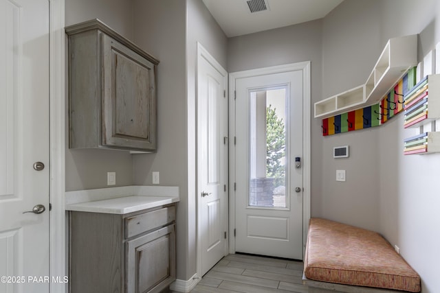 entryway featuring light wood-style flooring and visible vents