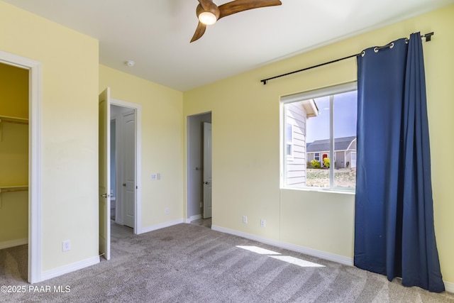 unfurnished bedroom featuring baseboards, ceiling fan, and carpet floors