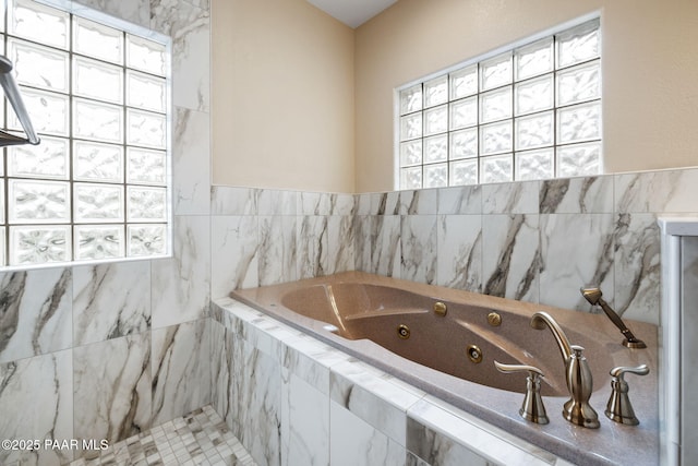 full bathroom with a jetted tub and a wealth of natural light