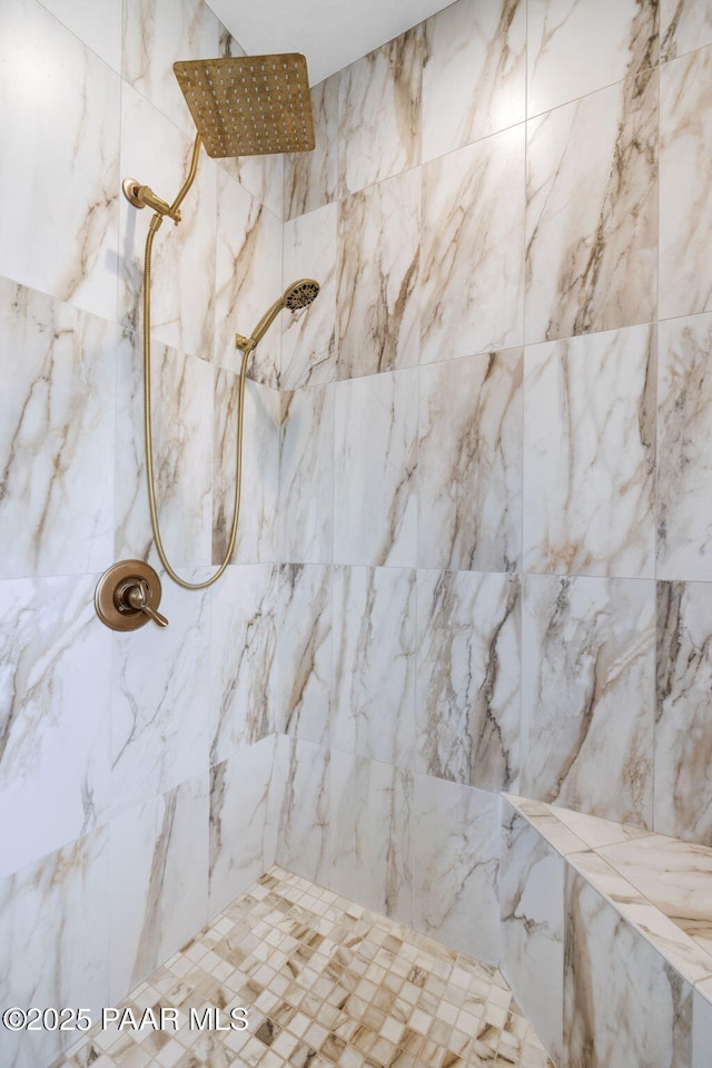 bathroom with tiled shower