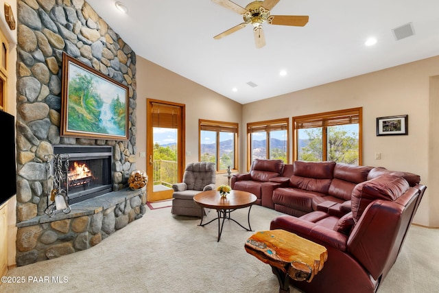 carpeted living room featuring visible vents, high vaulted ceiling, recessed lighting, a stone fireplace, and ceiling fan