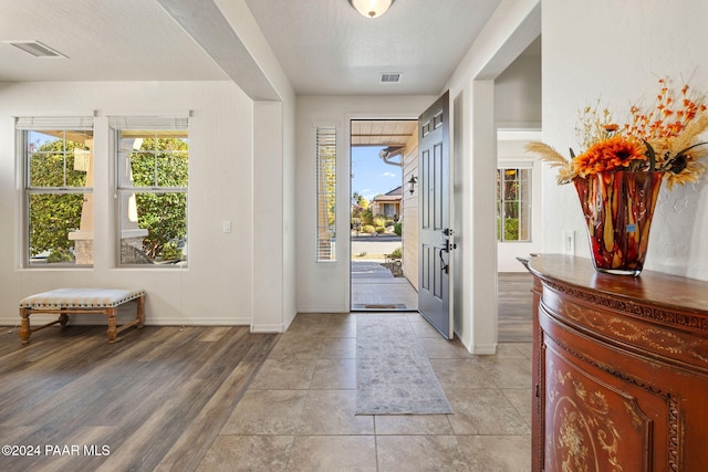 foyer featuring a textured ceiling and light wood-type flooring