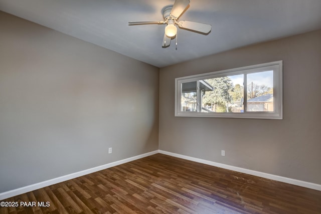 empty room with ceiling fan and dark hardwood / wood-style flooring