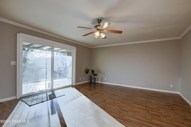 empty room with ornamental molding, dark hardwood / wood-style floors, and ceiling fan