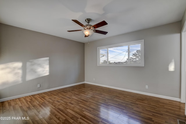 unfurnished room featuring dark hardwood / wood-style floors and ceiling fan