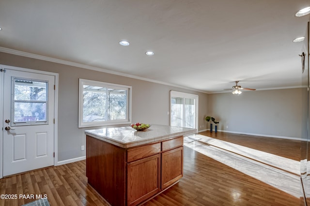 kitchen featuring ornamental molding, a healthy amount of sunlight, and a kitchen island