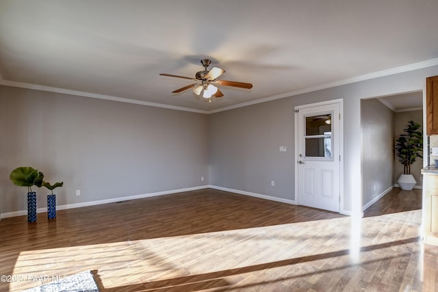 unfurnished room with dark hardwood / wood-style flooring, ornamental molding, and ceiling fan