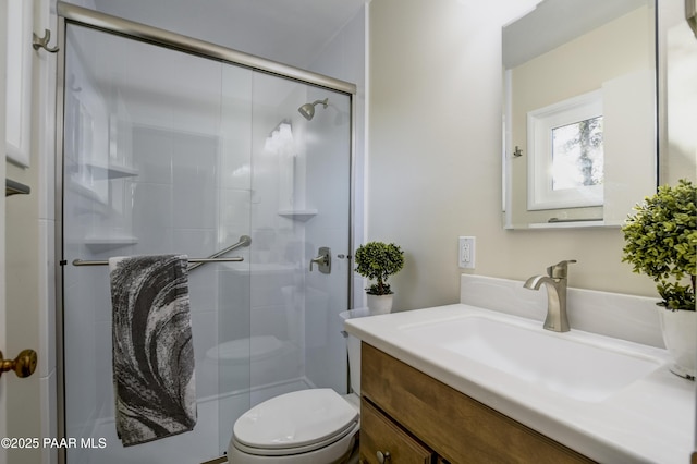 bathroom with vanity, toilet, and walk in shower