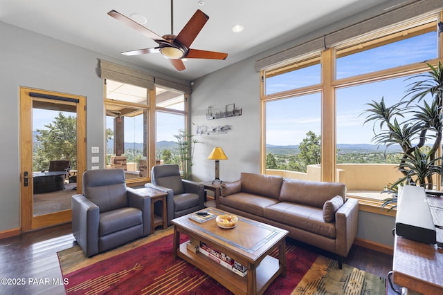 living room with plenty of natural light, dark hardwood / wood-style floors, and ceiling fan