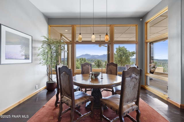 dining space with dark wood-type flooring and a mountain view