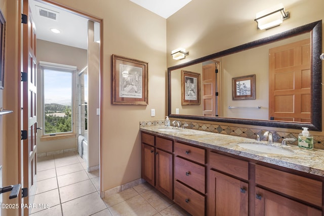 bathroom featuring tile patterned flooring, vanity, and washtub / shower combination