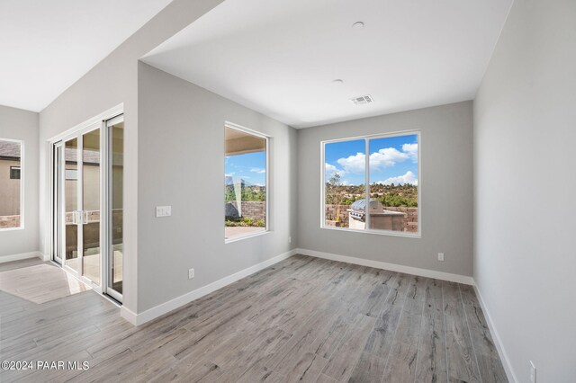 spare room with light hardwood / wood-style flooring