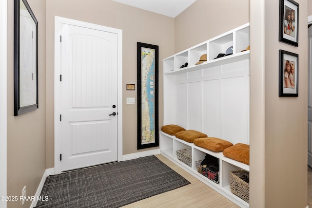 mudroom with wood finished floors and baseboards