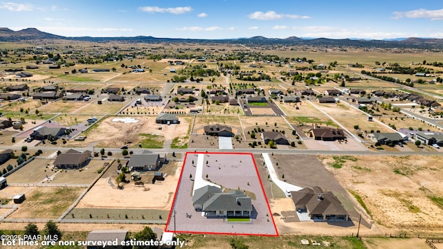 birds eye view of property featuring a mountain view