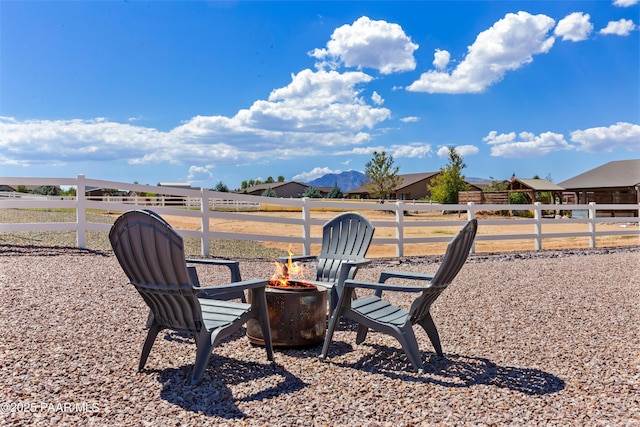 view of yard with an outdoor fire pit and fence