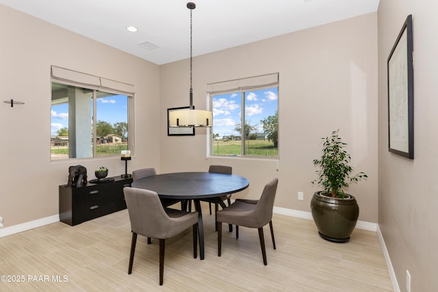 dining room featuring recessed lighting, plenty of natural light, visible vents, and baseboards