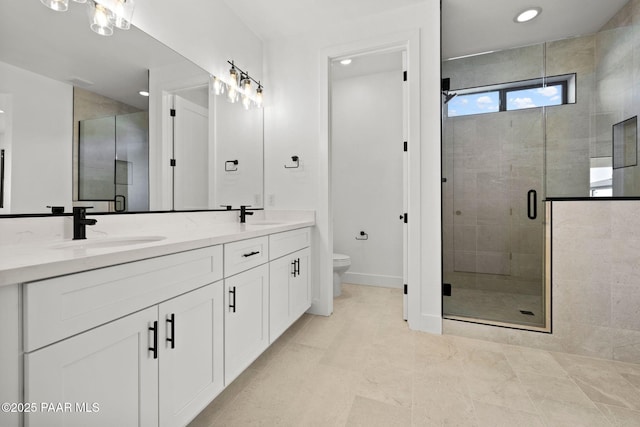 bathroom with vanity, toilet, and a shower with shower door